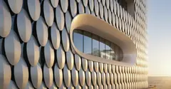 Facade of overlapping metal scales around a curved window