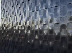 Grid of embossed metal panels with changing relief